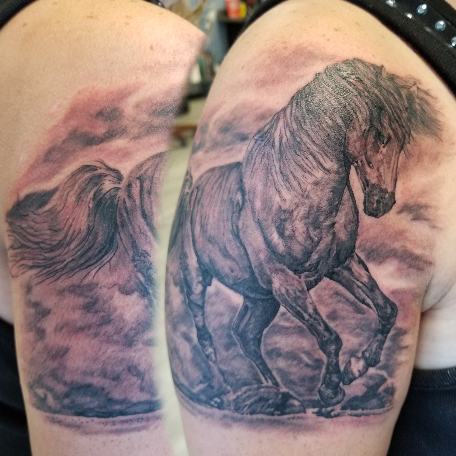 Strong horse running in sand during a storm. Head down keep keeping on. Black and grey tattoo to stand the test of time.