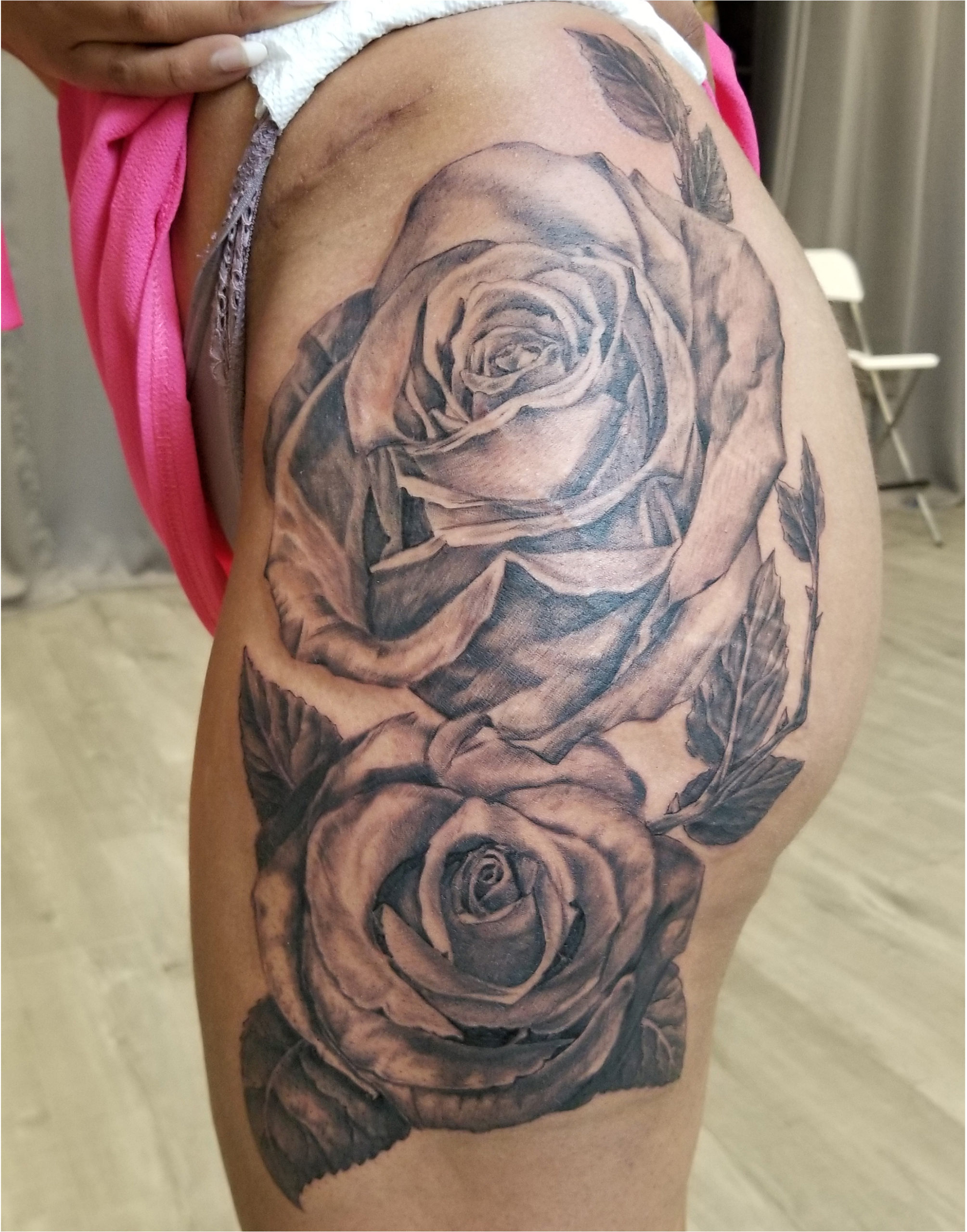 LArge roses tattoo on thigh.  Black adn grey for a vintage photo realistic look.